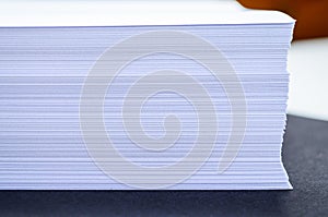 Stack of papers with blurred background, close-up, office documents and workspace