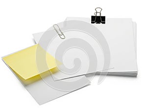 Stack of papers with clip and note isolated on white background