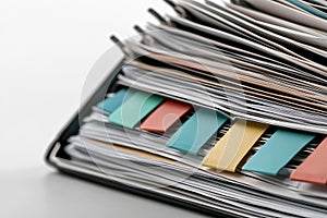 A stack of papers with colorful sticky notes on them