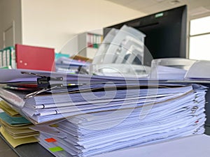 Stack of papers documents in archives files with clip papers on table at offices, Busy offices and Pile of data unfinished folders