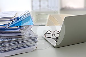 Stack of papers and glasses lying on table