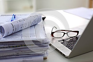 Stack of papers and glasses lying on table