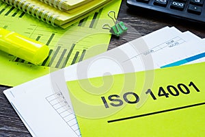 Stack of papers about ISO 14001 in the office. photo