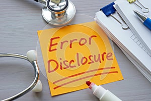 Stack of papers, medical stethoscope and note error disclosure. photo