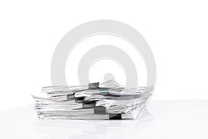 Stack of papers with paper clips, office folders. White isolated background