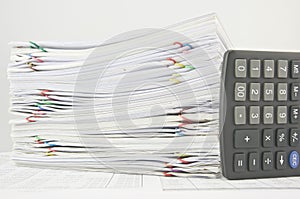 Stack paperwork of sales and receipt with calculator