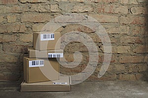 Stack of parcels on the floor against brick wall.Empty space.Storage premises