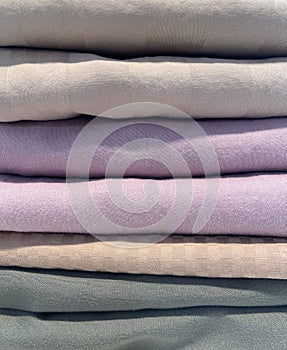 A Stack of Pastel Colored Pillowcases