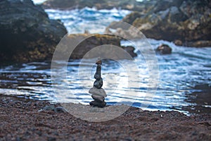 Stack of pebbles stone against sea background for spa, balance, meditation and zen theme.