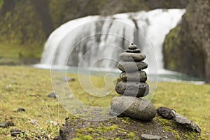 Stack of pebbles and waterfall