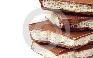 stack pieces of porous white and dark chocolate, macro