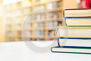 Stack and pile of books on tableublic or school library. in p