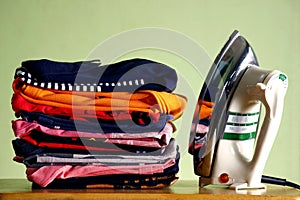 Stack or pile of folded shirts and an iron