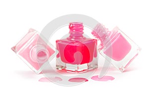 Stack of pink nail polish isolated on white background