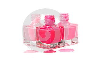 Stack of pink nail polish isolated on white background