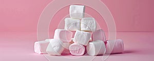 Stack of pink and white marshmallows on pink background, sweet dessert concept