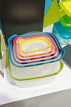 Stack of plastic containers with different sizes and lid colors