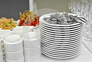 Stack of plates and tea spoons