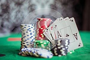 Stack of poker chips and four aces