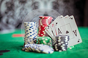 Stack of poker chips and four aces