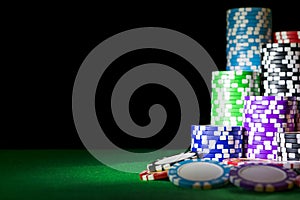 Stack of Poker chips on a green gaming poker table at the casino. Poker game concept. Playing a game with dice. Casino Concept