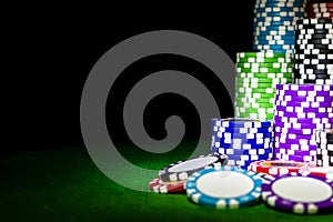 Stack of Poker chips on a green gaming poker table at the casino. Poker game concept. Playing a game with dice. Casino Concept