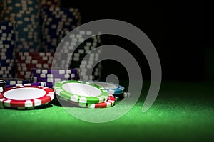 Stack of Poker chips on a green gaming poker table at the casino. Poker game concept. Playing a game with dice. Casino Concept