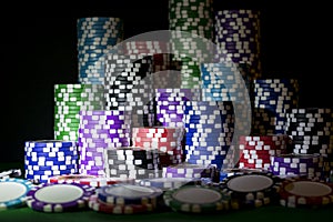 Stack of Poker chips on a green gaming poker table at the casino. Poker game concept. Playing a game with dice. Casino Concept