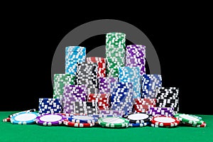 Stack of Poker chips on a green gaming poker table with poker dice at the casino . Playing a game with dice. Casino dice Concept