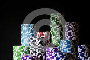 Stack of Poker chips on a green gaming poker table at the casino. Poker game concept. Playing a game with dice. Casino Concept