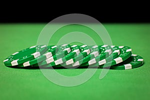 Stack of poker chips on a green table