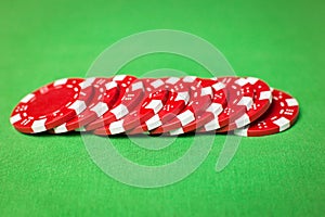 Stack of poker chips on a green table