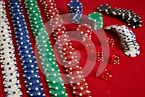 Stack of poker chips on red background at casino