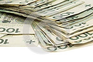 Stack of Polish 100 zloty banknotes on a white background.