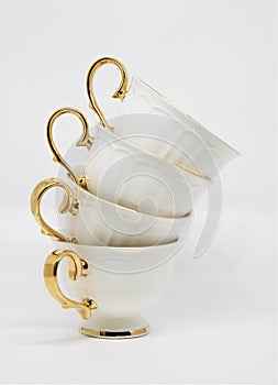 Stack of porcelain tea cups on white background