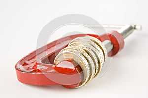 Stack of pound coins in clamp