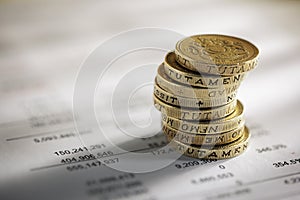 Stack of pound coins on financial figures