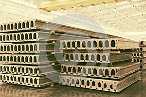 Stack of precast reinforced concrete slabs in a factory workshop