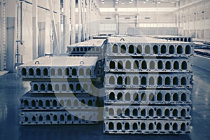 Stack of precast reinforced concrete slabs in factory workshop