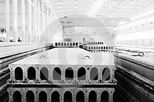 Stack of precast reinforced concrete slabs in factory workshop