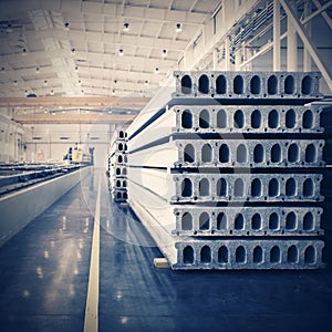 Stack of precast reinforced concrete slabs in factory workshop