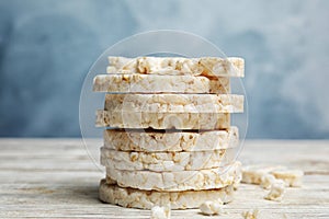 Stack of puffed rice cakes on white table against light blue background