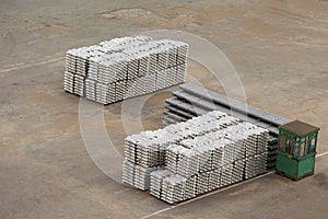 Stack of raw aluminium ingots in a warehouse at a trading port
