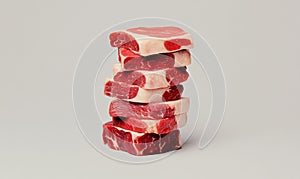 Stack of Raw Beef Steaks on Neutral Background