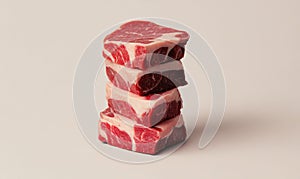 Stack of Raw Beef Steaks on Neutral Background