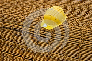 Stack of rebar grids with yellow helmet