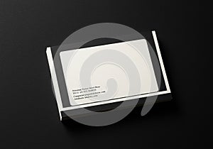 A stack of rectangular business cards with a minimalist design. Each card features