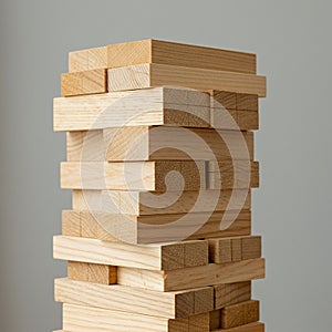 A stack of rectangular wooden blocks is arranged in an alternating pattern, resemblin photo