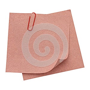 Stack of recycled paper sheets with red paper clip
