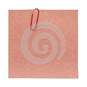 Stack of recycled paper sheets with red paper clip